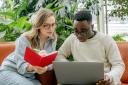 Woman and man looking at laptop together